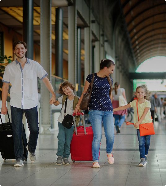 Family walking with suitcases