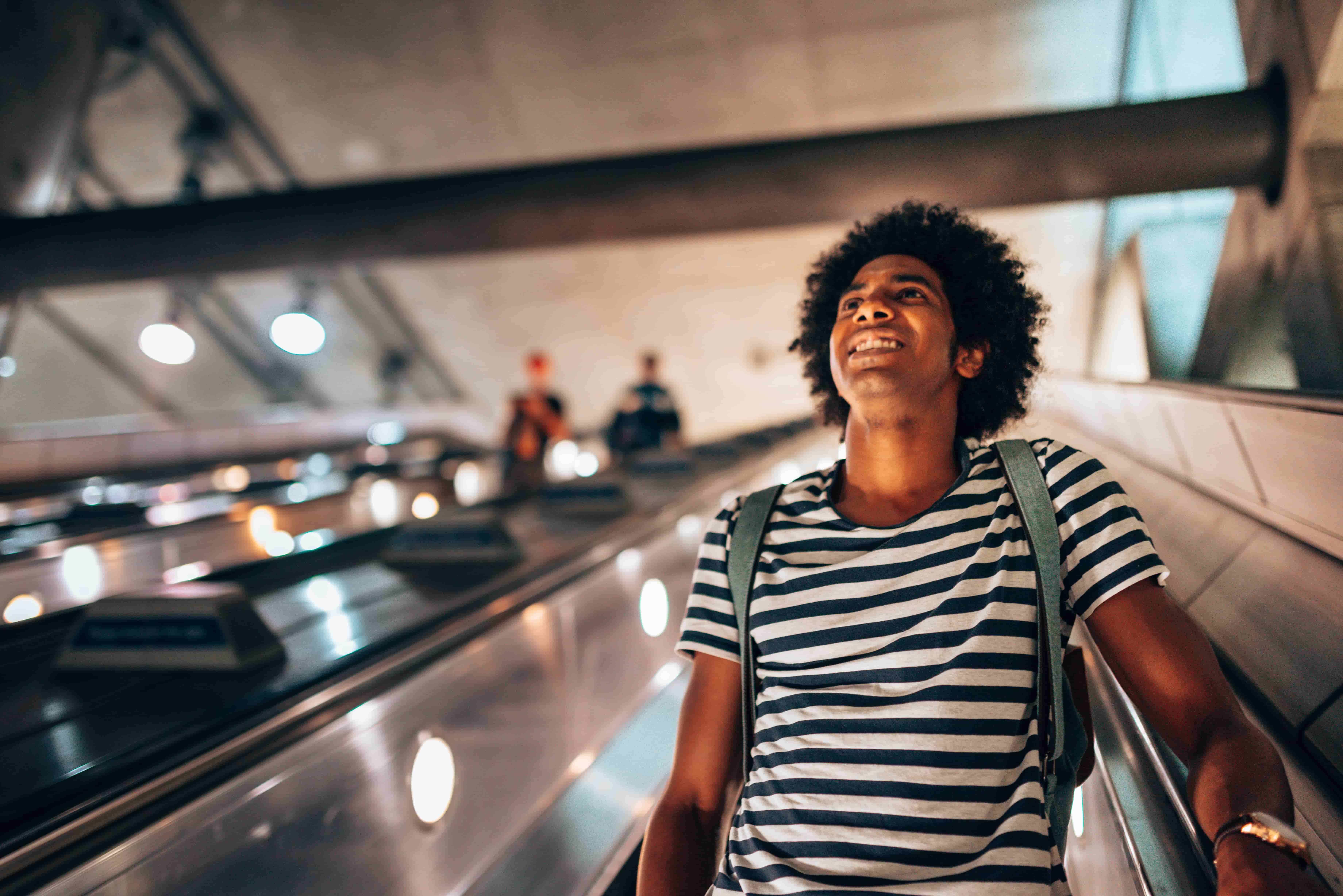 Man coming down escalator