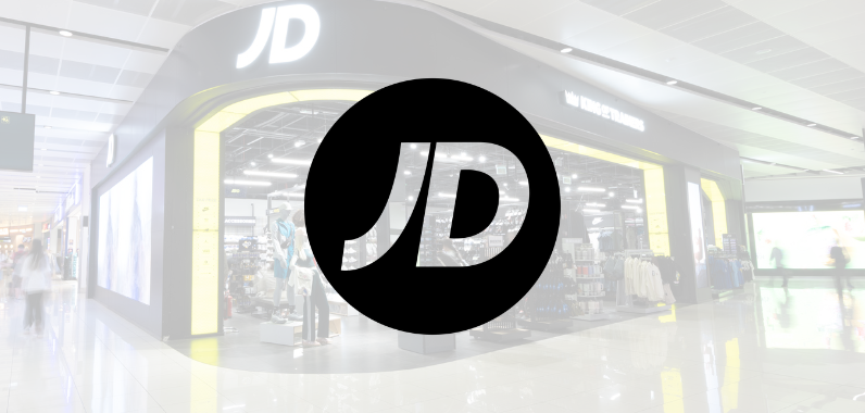 JD Sports store entrance with logo prominently displayed over a modern and sleek store interior, featuring clothing and sportswear.