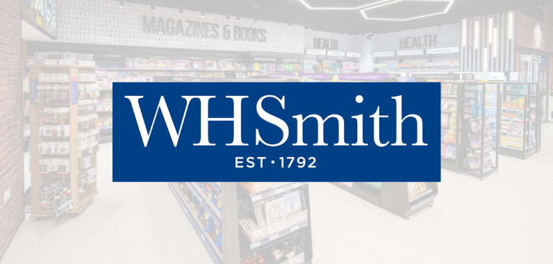 WHSmith store interior with shelves filled with magazines, books, and health products. Logo overlay shows "WHSmith EST. 1792" in white on blue.