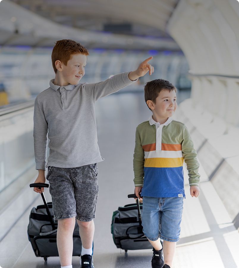 Two little boys walking through skylink