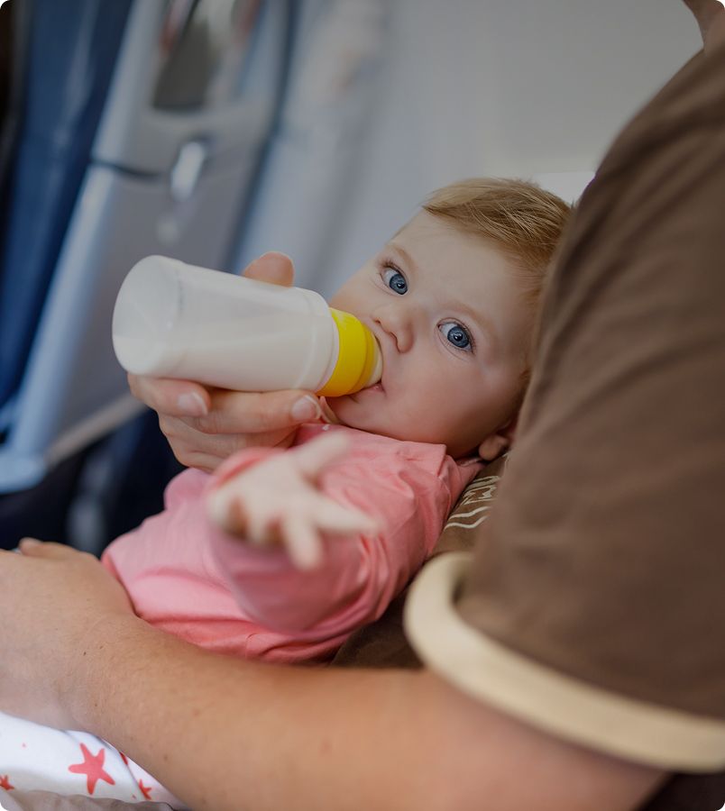 Baby getting fed with bottle