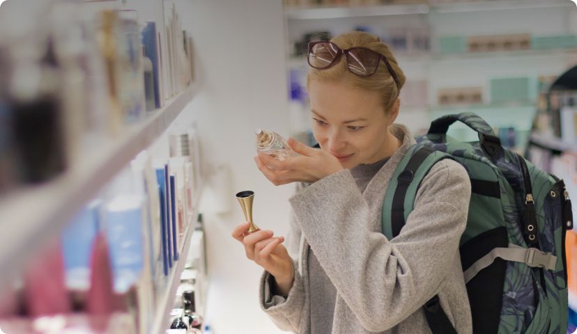 Woman smelling perfume on her wrist
