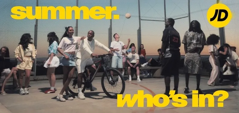 Group of young people enjoying summer activities on a rooftop court, featuring a bicycle and a volleyball, with bold yellow text overlay.